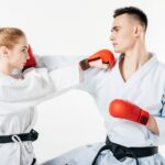 side view of karate fighters exercising isolated on white