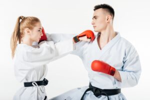 side view of karate fighters exercising isolated on white